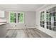 Bright dining area featuring sleek floors, a window, and access to the outdoors through glass doors at 6549 Biscayne Way, Douglasville, GA 30135