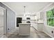 Modern kitchen with white cabinets, granite countertops, an island and stainless steel appliances at 6549 Biscayne Way, Douglasville, GA 30135