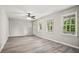 Bright living room featuring sleek floors, a ceiling fan and large windows with scenic outdoor views at 6549 Biscayne Way, Douglasville, GA 30135
