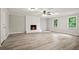 Open living room features sleek floors, a fireplace, and large windows offering ample natural light at 6549 Biscayne Way, Douglasville, GA 30135