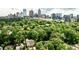 Expansive aerial view of a tree-lined neighborhood with the city skyline in the background at 171 Beverly Ne Rd, Atlanta, GA 30309
