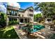 Inviting backyard oasis with a sparkling pool, lush landscaping, and an outdoor lounge area at 171 Beverly Ne Rd, Atlanta, GA 30309