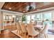 Dining room with hardwood ceiling, large windows, and open to the kitchen with barstool seating at 171 Beverly Ne Rd, Atlanta, GA 30309