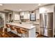 The eat-in kitchen features stainless appliances, white cabinetry, a breakfast bar, and a subway tile backsplash at 171 Beverly Ne Rd, Atlanta, GA 30309