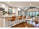 Modern kitchen with stainless steel appliances, white cabinets, bar seating, and an open layout to the living room at 171 Beverly Ne Rd, Atlanta, GA 30309