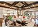 Open-concept living room with coffered ceiling, stylish furnishings, and seamless access to kitchen at 171 Beverly Ne Rd, Atlanta, GA 30309