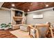 Cozy living area features a painted brick fireplace, hardwood ceiling, and comfortable seating area at 171 Beverly Ne Rd, Atlanta, GA 30309