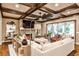 Inviting living room featuring coffered ceilings, a stone fireplace, and sliding doors to an outdoor patio at 171 Beverly Ne Rd, Atlanta, GA 30309