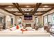 Cozy living room featuring a stone fireplace, coffered ceiling, and comfortable seating at 171 Beverly Ne Rd, Atlanta, GA 30309