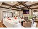 Comfortable living room with a stone fireplace, coffered ceiling, and seamless transition to the outdoors at 171 Beverly Ne Rd, Atlanta, GA 30309