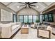 An airy living room with a vaulted ceiling, ceiling fan, modern furnishings, and plenty of natural light at 171 Beverly Ne Rd, Atlanta, GA 30309