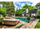 Serene backyard with a glistening pool, outdoor fireplace, and comfortable lounge furniture at 171 Beverly Ne Rd, Atlanta, GA 30309
