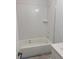 Bright bathroom featuring a soaking tub with white tile surround and modern fixtures at 1735 Fulmont Cir, Mableton, GA 30126