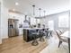 Bright kitchen features an island with stools, stainless steel appliances, and stylish pendant lighting at 1735 Fulmont Cir, Mableton, GA 30126