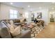 Inviting living room with comfortable gray sofa, stylish decor, and ample natural light, creating a relaxing atmosphere at 1735 Fulmont Cir, Mableton, GA 30126