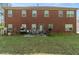 Large backyard with a patio area, great for entertaining guests, and a red brick house at 1905 Buford Ct, Conyers, GA 30094