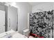 Neutral bathroom featuring a combination tub and shower, toilet, and a vanity sink with a large mirror at 1905 Buford Ct, Conyers, GA 30094