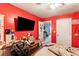 Red bedroom with an HD TV, an open door, and a window at 1905 Buford Ct, Conyers, GA 30094