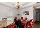 Well-lit dining room with a chandelier, wainscoting, and large windows at 1905 Buford Ct, Conyers, GA 30094