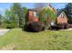 Charming brick home with a well-manicured lawn and mature landscaping at 1905 Buford Ct, Conyers, GA 30094