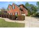Brick home with attached garage, driveway, and manicured landscaping at 1905 Buford Ct, Conyers, GA 30094