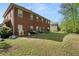 Backyard featuring a brick house with a spacious patio area and lush greenery, perfect for outdoor living at 1905 Buford Ct, Conyers, GA 30094