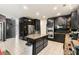 Stylish kitchen with tiled floors, dark cabinets, stainless steel appliances, and granite counters at 1905 Buford Ct, Conyers, GA 30094