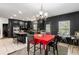 Spacious kitchen and dining area with sleek, dark cabinetry and a tiled floor at 1905 Buford Ct, Conyers, GA 30094