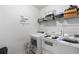 Functional laundry room equipped with modern washer, dryer, and ample shelving for storage at 1905 Buford Ct, Conyers, GA 30094