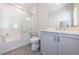 This bathroom has a tub-shower with a glass door and a modern vanity at 4046 Hazel Nut Ln, Atlanta, GA 30342