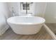 Freestanding tub with chrome fixtures and next to a glass shower in a bright bathroom at 4046 Hazel Nut Ln, Atlanta, GA 30342