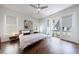 Bright bedroom featuring hardwood floors, neutral walls, ceiling fan and access to a balcony at 4046 Hazel Nut Ln, Atlanta, GA 30342