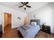 Cozy bedroom features a ceiling fan, stylish decor, and hardwood flooring at 4046 Hazel Nut Ln, Atlanta, GA 30342
