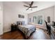 This bright bedroom has a ceiling fan, large window, and hardwood flooring at 4046 Hazel Nut Ln, Atlanta, GA 30342