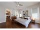 Bedroom with dark hardwood floors, neutral walls, an adjoining office and a drink refrigerator at 4046 Hazel Nut Ln, Atlanta, GA 30342