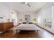 Minimalist bedroom with hardwood floors, platform bed, ceiling fan and access to outdoor balcony at 4046 Hazel Nut Ln, Atlanta, GA 30342