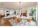 Open-concept dining area with modern furniture, hardwood floors, and ample natural light at 4046 Hazel Nut Ln, Atlanta, GA 30342