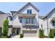 Charming two-story home featuring a balcony, an attached garage, and manicured landscaping at 4046 Hazel Nut Ln, Atlanta, GA 30342