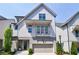 Charming two-story home featuring a balcony, front garden, and attached garage at 4046 Hazel Nut Ln, Atlanta, GA 30342
