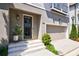 Close-up of home's front entrance, featuring a stylish front door, white stairs, and a manicured lawn at 4046 Hazel Nut Ln, Atlanta, GA 30342