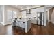 Bright kitchen with white cabinets, stainless steel appliances, center island, and hardwood flooring at 4046 Hazel Nut Ln, Atlanta, GA 30342