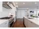 Gourmet kitchen featuring stainless steel appliances, a large island, and open access to the living room at 4046 Hazel Nut Ln, Atlanta, GA 30342