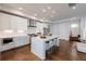 Open concept kitchen with white cabinets, stainless steel appliances, and a center island with bar seating at 4046 Hazel Nut Ln, Atlanta, GA 30342