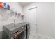 Laundry room featuring modern washer and dryer, shelving, and decorative flooring at 4046 Hazel Nut Ln, Atlanta, GA 30342