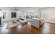 Open-concept living room with hardwood floors, stylish decor, and abundant natural light from large windows at 4046 Hazel Nut Ln, Atlanta, GA 30342