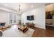 Living room boasts an open layout, hardwood floors, and access to the patio at 4046 Hazel Nut Ln, Atlanta, GA 30342