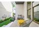 Relax on this cozy patio featuring modern chairs, a vibrant yellow table, and lush greenery at 4046 Hazel Nut Ln, Atlanta, GA 30342