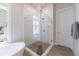 Glass-enclosed shower with white tiled walls and chrome fixtures in a bright bathroom at 4046 Hazel Nut Ln, Atlanta, GA 30342