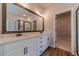Contemporary bathroom with double vanity, a large mirror and access to the walk-in closet at 1482 Alcovy Station Rd, Covington, GA 30014