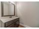 Modern bathroom features a dark vanity with light countertop and wood-look flooring at 1482 Alcovy Station Rd, Covington, GA 30014